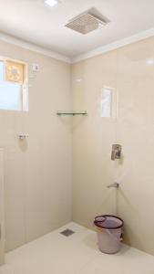 a bathroom with a toilet and a glass shower at Estate IV - Saffron Suite - Tea Estate Stay in Vythiri +32 photos