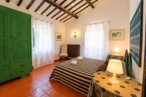 a bedroom with a bed and a green door at Casa Adele - 10 min from the sea! in Carignano
