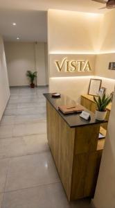 a vista lobby with a visa sign on the wall at Hotel Vista by Booksy One Kollam Near Kollam Bypass in Kollam
