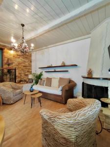 a living room with a couch and a fireplace at Forest view evia in Prokópion