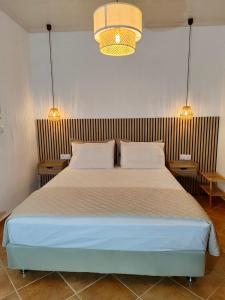 a bedroom with a large bed with two pillows at Forest view evia in Prokópion