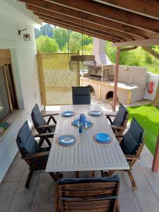 a wooden table with blue plates on top of it at Forest view evia in Prokópion