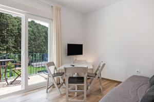 a living room with a table and chairs and a window at Casa de 10 - 2a in Vejer de la Frontera