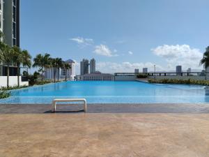 a large swimming pool on top of a building at Metropol Summer Cozy Suite in Bukit Mertajam