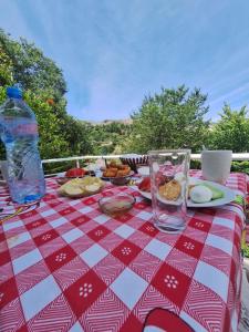 a table with a red and white checkered table cloth at Guest House Argjiro Castle in Gjirokastër +52 photos