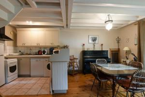 a kitchen and dining room with a table and chairs at Cottages Croix L'abbé, les Mouettes in Saint-Valéry-sur-Somme