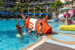 a family playing in a pool at a resort at Phuket Marriott Resort & Spa, Merlin Beach in Patong Beach