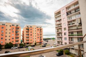 a view of a parking lot in a city with buildings at Summerland Lake View Apartament in Mamaia