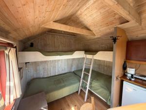 a room with two bunk beds and a ladder at Horns Skärgårdscamping in Nyköping