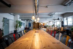 a long wooden table in a room with chairs at Das Boot Triberg in Triberg