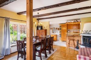 a kitchen and dining room with a table and chairs at Haus am See in Witzin