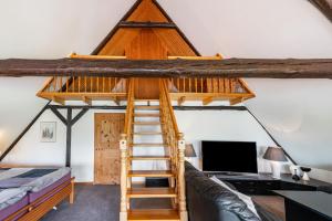 a room with a loft bed and a desk at Haus am See in Witzin