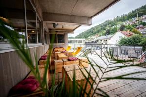 a balcony with chairs and tables on a building at Das Boot Triberg in Triberg