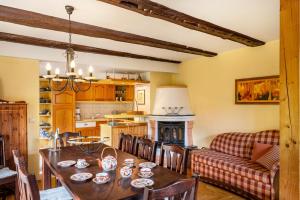 a kitchen and dining room with a table and a couch at Haus am See in Witzin +28 photos