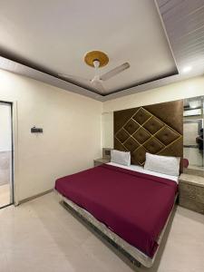 a bedroom with a large bed in a room at Roshan Residency in Matheran
