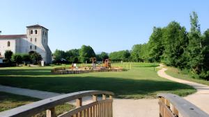 a park with a playground and a church at Gite Karrikartea in Saint-Pée-sur-Nivelle