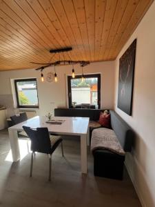 a living room with a white table and a couch at Tannennest in Seewald