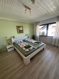 a bedroom with a large bed in a room at Tannennest in Seewald +9 photos