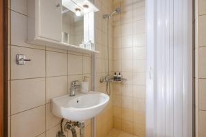 a bathroom with a sink and a mirror at Villa Melenia 1 in Agia Pelagia +25 photos