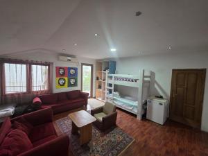 a living room with a couch and a bunk bed at Merabi Guest House in Makhinjauri