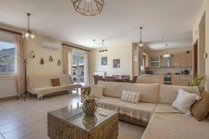 a living room with a couch and a table at Villa Melenia 1 in Agia Pelagia