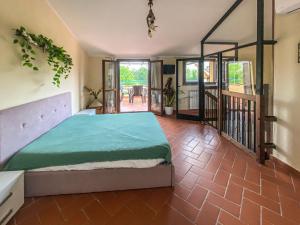 a bedroom with a large bed and a balcony at Casa Le Marie in Barberino di Mugello