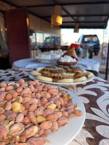 a table with plates of food on top at Camp Luxury in Merzouga in Merzouga +22 photos