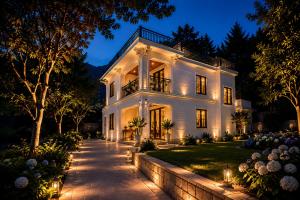 a large white house at night with lights at SaPa PAPA - Architect's Hidden Sanctuary - Only 4 rooms hidden in a secret botanical garden - 3 minutes from Sapa Station - Privacy & Privilege for stylish insiders in Sapa