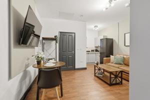 a living room with a table and a couch at Clayton Apartments in Newcastle upon Tyne