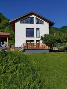 a house on a hill with a green field at Hiša Lenart in Tolmin