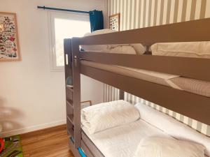 two bunk beds in a room with a window at Cap d'Equih' in Équihen-Plage