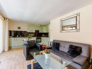 a living room with a couch and a table at 1 Bed in Cinderford oc-82884 in Cinderford
