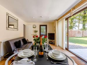a living room with a table and a couch at 1 Bed in Cinderford oc-82884 in Cinderford