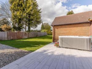 a backyard of a house with a heater on a patio at 1 Bed in Cinderford oc-82884 in Cinderford +5 photos