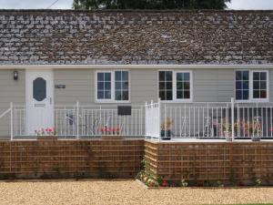 a white fence in front of a house at 1 Bed in Cinderford oc-88271 in Cinderford