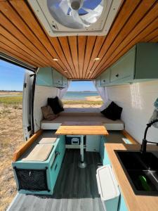 an inside view of an rv with a table in it at Campervan's Algarve in Albufeira