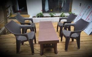 a group of chairs and a wooden table and sidx sidx sidx sidx at WayFare Stud Farm & Resort in Nashik