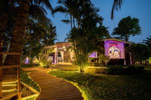a house with purple lights on the front of it at WayFare Stud Farm & Resort in Nashik