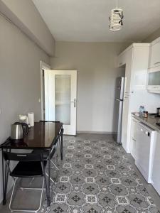 a kitchen with a table and a floor in a room at Adrasan village house in Kumluca