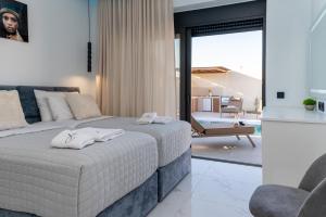 a bedroom with a bed with white towels on it at Amfi Luxury Villa 4BR with Private Pool by Villa Mana Gers in Sarakinádhon +105 photos