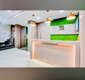 a lobby with a green wall in a building at Ganges Pride Hotel in Haridwār +17 photos