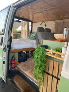 an open door of a van with a bed and plants at Campervan's Algarve in Albufeira