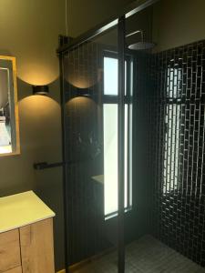 a shower with a glass door in a bathroom at Croxley Farm in Robertson