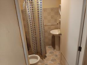 a bathroom with a shower with a toilet and a sink at Buffalo Bay Vacation Club in Ko Phayam