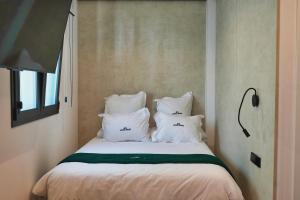 a bed with white pillows in a room at Azure Homes in Conil de la Frontera +59 photos