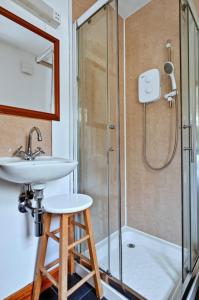 a bathroom with a sink and a shower at Lochead Cottage Ellary in Lochgilphead +4 photos