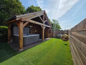 a gazebo with a hot tub in a garden at Sunnie view lodge 2 bedroom in Lound