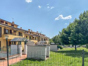 a building with a fence in front of a yard at Casa Le Marie in Barberino di Mugello