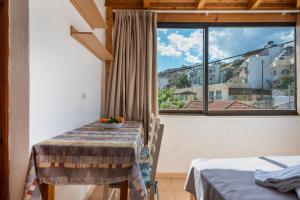 a room with a table and a large window at Nikos House in Ierapetra +114 photos