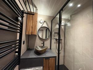 a bathroom with a sink and a mirror at Flocons 48 in Villarembert +13 photos